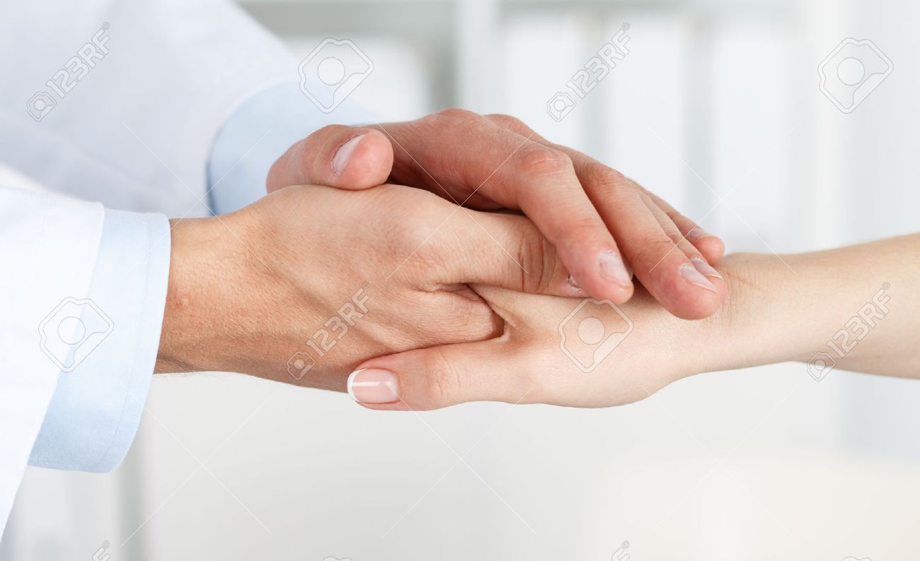 42889828-friendly-male-doctor-s-hands-holding-female-patient-s-hand-for-encouragement-and-empathy-partnership